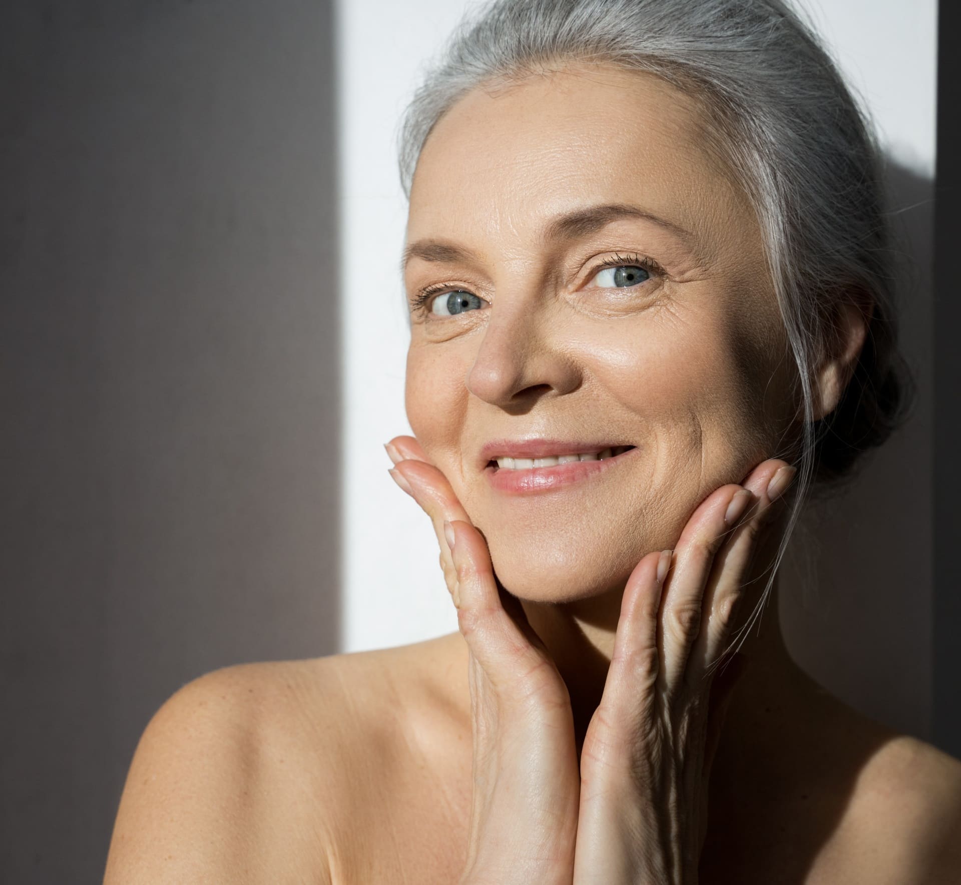 Mature woman with lifted, radiant skin after HIFU treatment