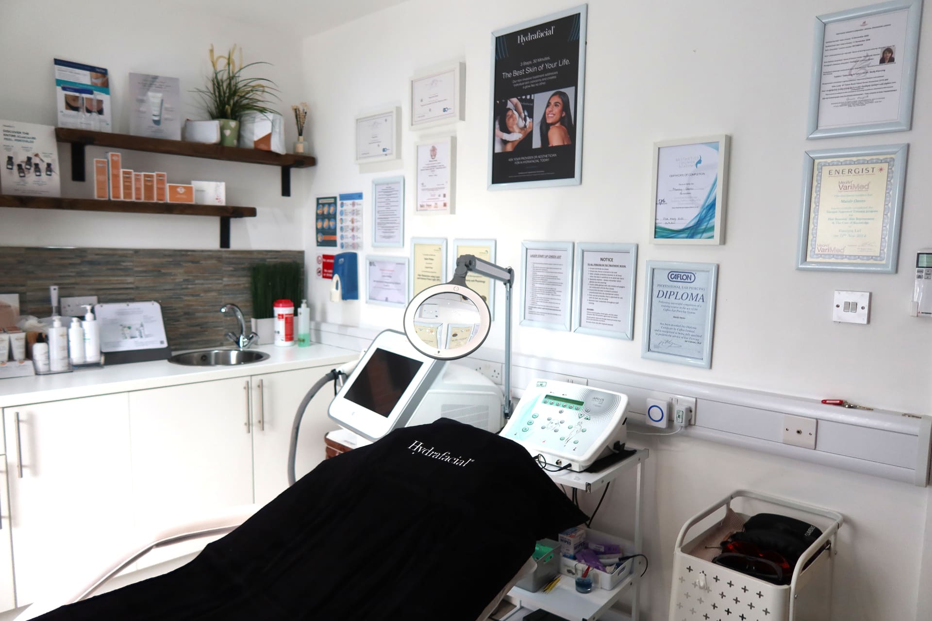 Treatment room with medical-grade devices and accreditations at Vale Laser Pontyclun