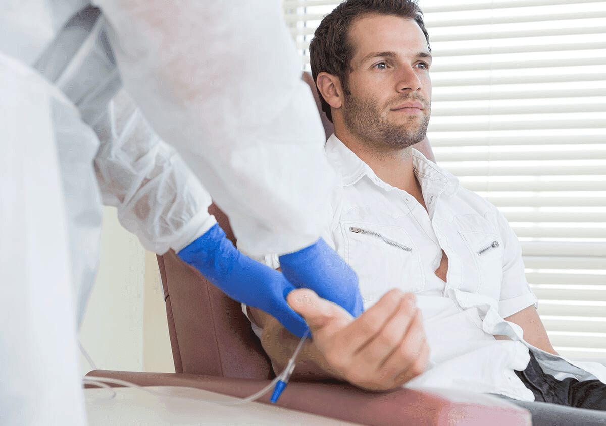 Male patient receiving IV vitamin drip therapy